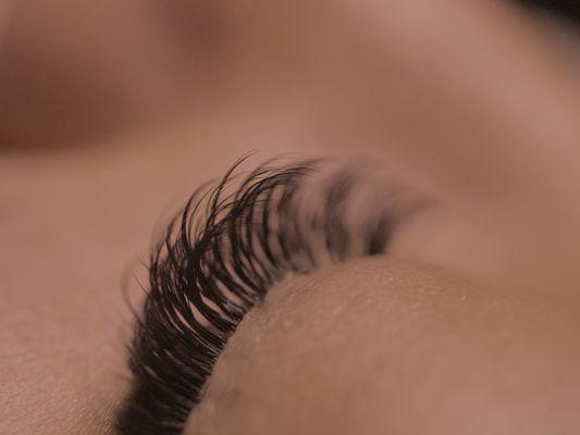 Individual Lash Extensions applied to the natural lashes leaving with proper application to ensure healthy lashes and comfortability.