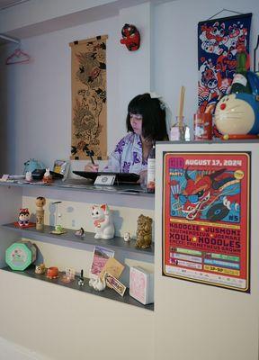 Shop owner, Mandy, working on new designs behind counter during Hai! Japantown