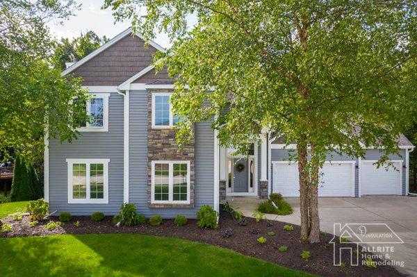 Our design consultant put together the beautiful combination of blue-gray siding, stone veneer and synthetic cedar accents.