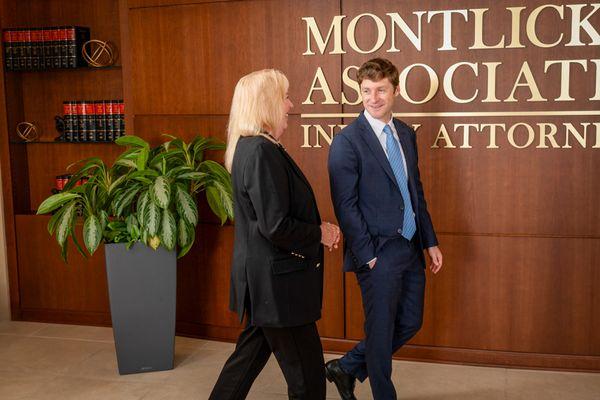 Two Montlick Injury Attorneys walking thru one of our lobbies.