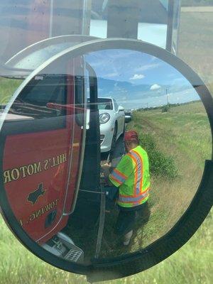 Mr. Hill securing our pretty car to his big rig. We got to ride in front w the AC!