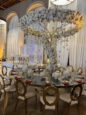 Serpentine Mirror Tables, Gold Oz chairs, Artificial Flower Structure