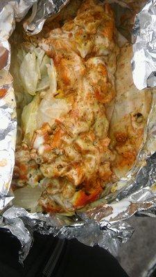 Chicken gyro with white sauce hot sauce lettuce and onions