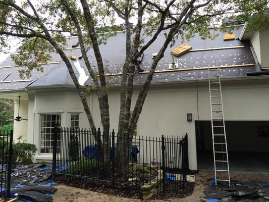 Production photos of full roof replacement in Austin.