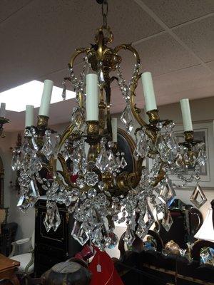 Numerous antique hanging fixtures and chandeliers of all shapes, sizes, and styles.