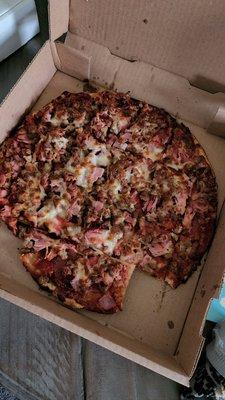 The 5 meat with "pineapple" pizza my husband ordered (he can barely chew the crust it is so crunchy burnt)