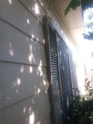 Shutters were pulled off in the storm and dented (before)