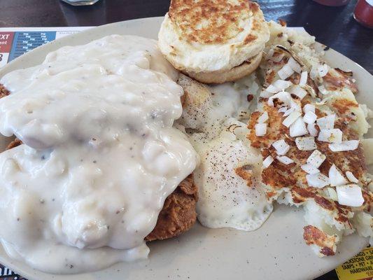 Chicken fried steak, eggs over easy w/biscuit and side of home fries.