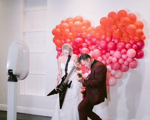 Bride & Groom having fun with the photo booth at the wedding