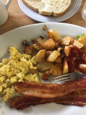 Regular big breakfast with three pieces of bacon home fries and scrambled eggs $6.99. They charge extra for coffee.