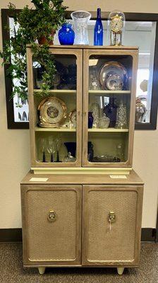 Beautiful redone hutch filled with beautiful gold china and blue glassware