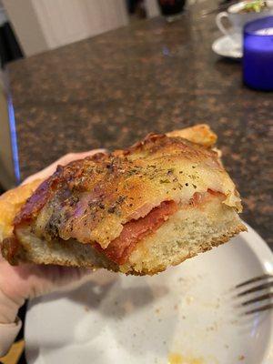 Meaty deep dish. Hardly any sauce is on it - making it very dry. The red you see is the meat and there is no sauce layer underneath.