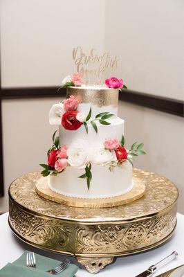 Buttercream frosting, gold leaf, three tier chocolate cake with assorted fillings.