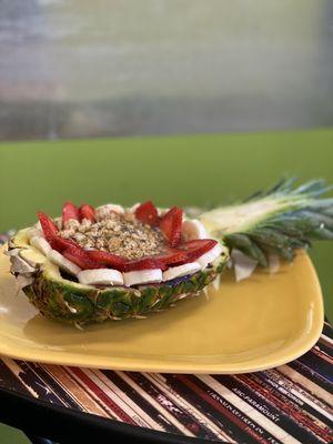 Açaí bowl in a pineapple half