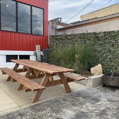 Outdoor patio has several tables.