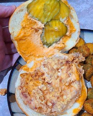 bun, sauce, pickles, fried chicken patty, and okra side.