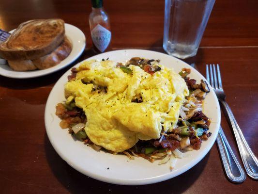 Country Skillet--3 eggs any style, bacon, sausage, ham, green pepper, onion, and tomato, on top of hash browns and side of toast.