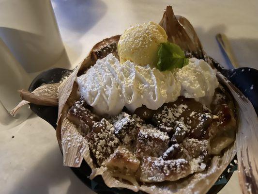 Bread pudding,ice cream and whipped cream in a tamale shell.