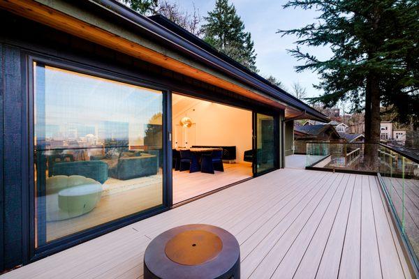 Panoramic door opening onto deck with view and glass railng