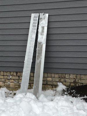 Gutter guards that were ripped off from the house and fell to the ground.