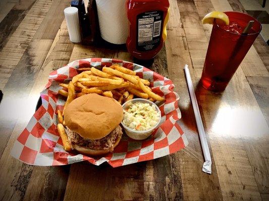 BBQ Basket Special - Pulled pork sandwich piled high on a toasted bun with hot lightly battered fries and sweet cole slaw.