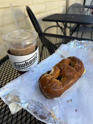 Iced mocha latte and bacon egg and cheese on salt pretzel.