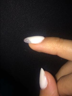 Lumpy texture (seen best on middle finger) and lack of paint/powder (seen best on edge of thumb)