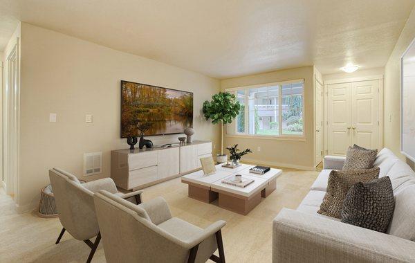 Staged living room featuring large windows.