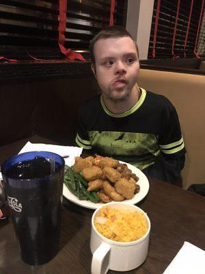 Chicken nuggets, asparagus, seafood and rice with Unsweetened Tea.