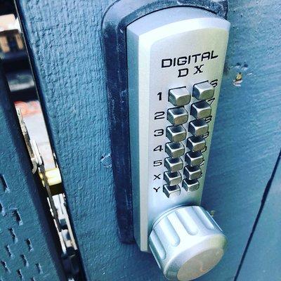 Mechanical keypad installation on a wooden gate.