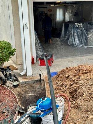 They dug this hole to run new liner under driveway and to street.  Also dug from here to back of garage for washer line.