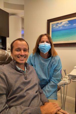 Dr. Ansari and I with all the tea stains scrubbed off my teeth and the beautiful, peaceful island oil painting behind us.