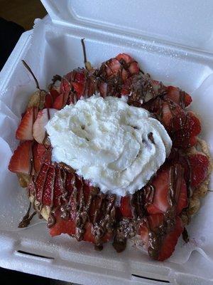 Funnel cake with Nutella, strawberries, and whipped cream