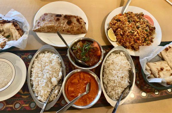 From left to right - Garlic Naan, Samosa Chat (top), Chicken Karahi (top), Chana Masala (bottom), Beef Biryani, Naan