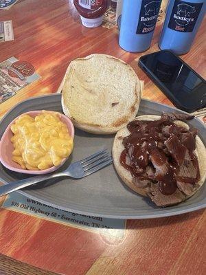 Brisket sandwich with bbq sauce and the small portion of Mac n cheese.