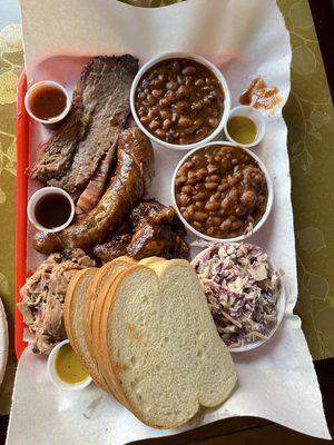 Top left corner brisket , middle burnt ends and sausage, under bread pulled pork & TURKEY! Sides beans and slaw.