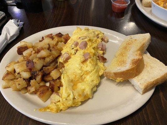 Porky's scrambler with breakfast potatoes and sourdough toast