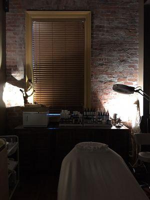 The treatment room featuring HydroPeptide and PCA Skin on the backbar.