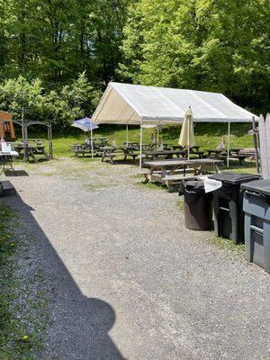 Some tables and umbrellas and a canopy on the side to dine al fresco