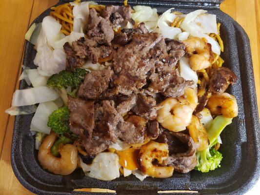 Beef and shrimp teriyaki with noodles and vegetables.