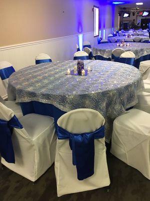 Star theme for this party is carried through with a white destiny sheer on a royal blue table cloth.