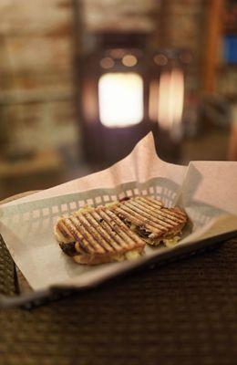 Mac and cheese bacon panini next to the fireplace