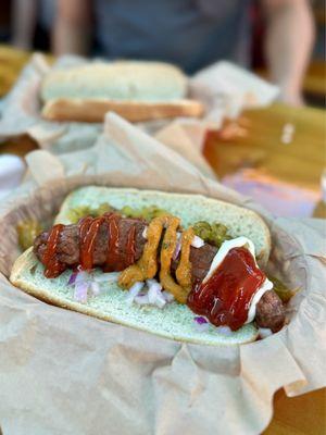 Bratwurst with several sauces: curry ketchup, jalapeño, mayo & regular ketchup