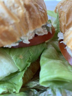 The sandwich valley between the two halves. Fresh tomato slice and crisp iceberg lettuce.