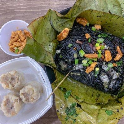 Pancit pusit (squid ink noodles) and pork siomai (shumai).