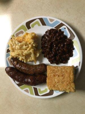 Sausage, cheesy potatoes, baked beans, and corn bread.