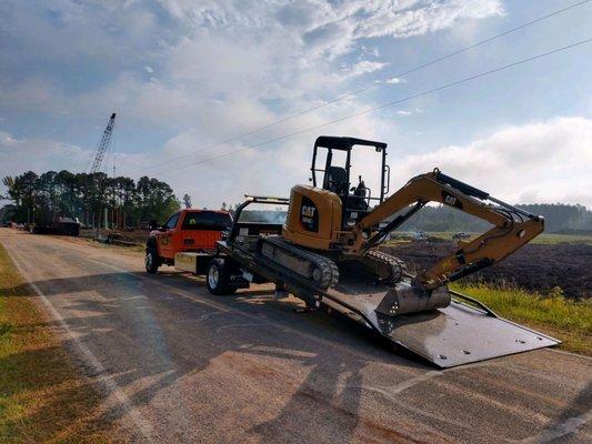 Excavator being hauled for work on the 295