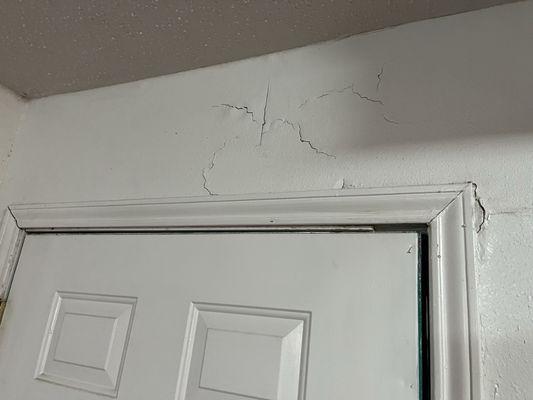 Plaster giving way above the door & several other place in the room.