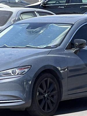 This is a photo of my vehicle at the tow yard. Notice it had the sun protector on it. You can see a small corner of my parking pass.