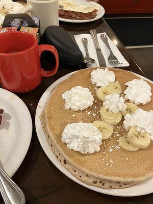 Pumpkin pancake with banana and whipped cream toppings